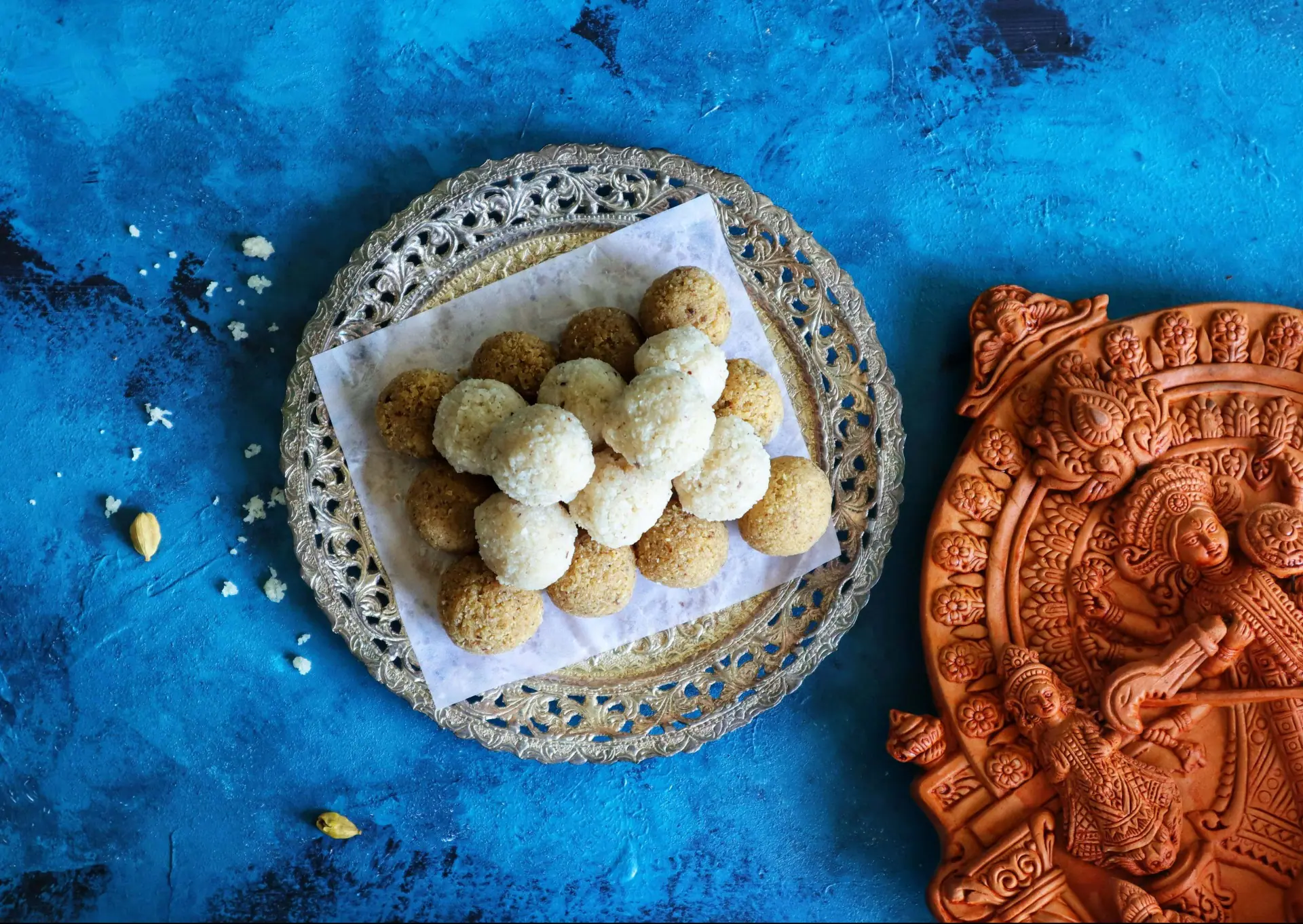  West Bengal delights in its traditional sweets, notably Narkel Naru, a coconut laddoo made with jaggery or sugar, particularly cherished when crafted with Nolen Gur for its rich flavor. Another festive favorite is Sandesh, a delicate treat made from fresh chhena and often flavored with cardamom or saffron. Together, these sweets embody the joy of the festival and the region’s love for milk-based delicacies, making them essential to the celebration.
