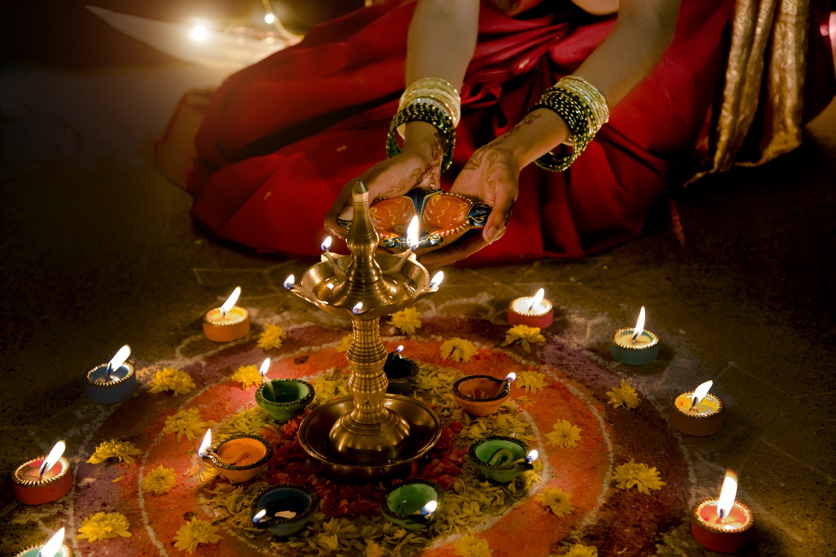  Diwali celebrations across India showcase diverse cultural traditions, with vibrant lights, decorations, and rituals unique to each region. This image features a festive setting with illuminated oil lamps, colorful rangoli patterns, and families joyously celebrating together, symbolizing unity and the triumph of light over darkness.