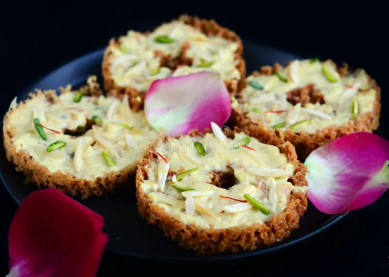 In Rajasthan, Diwali is celebrated with rich sweets reflecting the state’s royal heritage, Ghevar, a honeycomb-shaped dessert soaked in syrup, is iconic and especially popular during Diwali, made from flour, ghee, and sugar, Ghevar is often topped with pistachio and saffron, Balushahi is another beloved sweet, known for its flaky texture and mild sweetness, made from flour and deep-fried in ghee, Balushahi has a soft, crumbly interior that contrasts with its crispy exterior, Churma Ladoo, made from wheat flour, ghee, and jaggery, offers a nutty, caramelized flavor that makes it irresistible